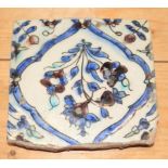 A 18th century Iznik tile, decorated floral spray, 5 1/2" square (some losses to borders)