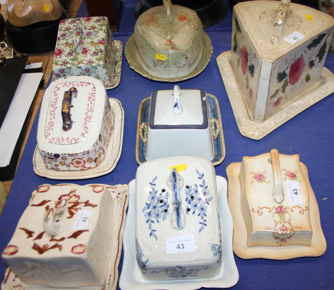 A chintzware cheese dish and cover, and six other cheese dishes and covers