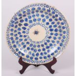 An 18th century Delft plate with all-over leaf and tendril design, 12" dia (rim chips)