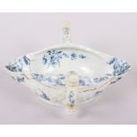 An 18th century English blue and white porcelain two-handle sauce boat (heavily restored)
