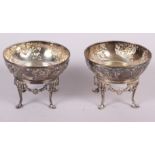 A pair of Arts & Crafts style bonbon dishes with embossed floral decoration and cast stands, 9.7oz