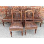A set of late Victorian carved walnut splat back dining chairs, upholstered in a leather, on