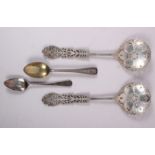 A pair of silver fruit servers with pierced and engraved decoration and two silver spoons, 5.9oz