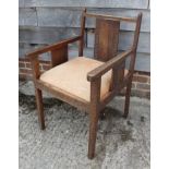 A carved teak open armchair with splat back and drop-in seat