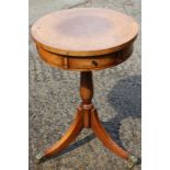 A Brights of Nettlebed burr walnut and banded circular top drum table, fitted two drawers, on tripod