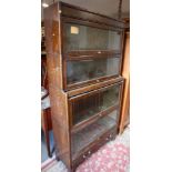 An oak sectional bookcase with four glazed divisions, 34" wide x 12" deep x 65" high