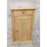 A pine bedside cupboard enclosed one drawer, on block base, 18 1/2" wide x 14 1/2" deep x 31" high