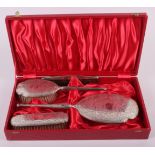 A silver four-piece dressing table set, in fitted case