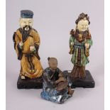 Two Chinese figures, on stands, largest 9 1/2" high, and another figure of a seated man, 5" high (