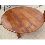 An oak circular low coffee table, on turned and stretchered supports, 48" dia x 19 1/2" high