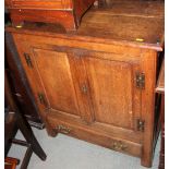 An early 19th century oak side cupboard enclosed two panelled doors over one drawer, on stile