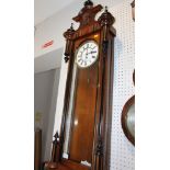 A 19th century walnut cased Vienna style wall clock with white enamel dial, 52" high
