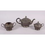 An Oriental white metal three-piece teaset with embossed decoration, 30.7oz troy approx