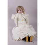 A late 19th century Columbia bisque head doll with kid body and contemporary lace edge clothes,