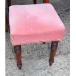 A 19th century mahogany stool with stuffed over seat, on turned supports