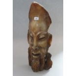 A carved soapstone door stop?, in the form of a man's head, 23 1/2" high