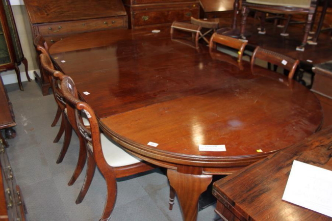 A 19th century mahogany extending dining table with three extra leaves, on cabriole supports and pad