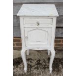 A Continental white painted hardwood and marble top bedside cabinet, on slender turned supports, 16"