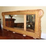 A carved giltwood overmantel mirror of early Georgian design with triple plate, 48" wide x 21 1/2"