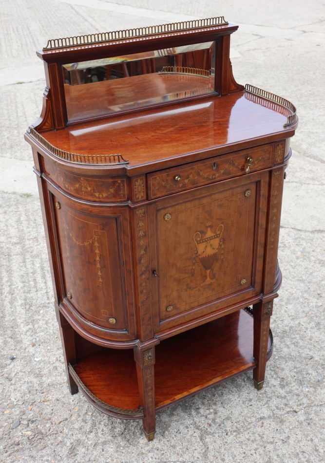 A late 19th century mahogany inlaid side cabinet with raised mirror back over enclosed panel door,