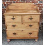 A waxed pine chest of two short and two long drawers with tray top