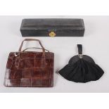A morocco leather scroll box with silk lining, a crocodile skin handbag and a black evening purse