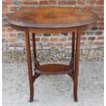 An Edwardian mahogany oval two-tier occasional table, 30" x 19"