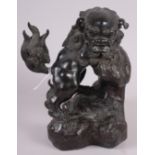 A Chinese bronze figure of a standing lion, 8" high