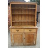 A waxed pine dresser, fitted shelves over two drawers and cupboards, on block base, 48" wide x 20"