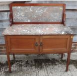 An Edwardian walnut top washstand with splashback and cupboards, on square taper supports, 42" wide