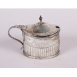 A Victorian silver oval mustard pot with half fluted and engraved decoration and blue glass liner,