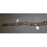 A sectional leather strap mounted with numerous WWII brass buttons, including RASC, Royal