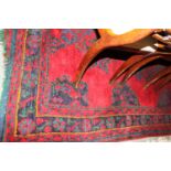 A turkey carpet of traditional design in shades of red, green, blue and yellow, 92" x 106" approx