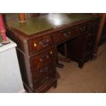A mahogany double pedestal desk with green tooled leather top, fitted nine drawers, on bracket feet,