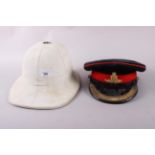 A Royal Artillery senior officer's dress cap and a white pith helmet