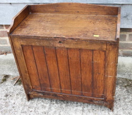 A late 19th century oak fall front writing cabinet with baize-lined slope, drawers and pigeon holes,