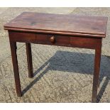 A late Georgian mahogany fold-over top tea table, fitted one frieze drawer, on chamfered supports,