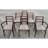 A set of six Gordon Russell style teak ladder back dining chairs with drop-in seats, on slender