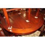 A Chinese hardwood circular extending dining table with two extra leaves, 46" x 84" when fully