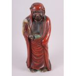 A Chinese porcelain figure of Daruma with a fly whisk, 15" high