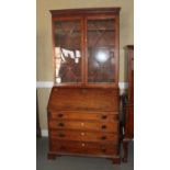 A George III mahogany bureau bookcase, the upper section enclosed astragal glazed doors, over fitted