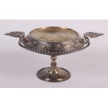 A silver pedestal dish with two cast handles and embossed decoration, 17.1oz troy approx