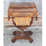 A 19th century rosewood flap top work table, on scrolled qudraform base, 34" wide x 17 1/2" deep x