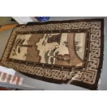 A Chinese rug in shades of brown and beige, rural scenes depicting trees, hills, stags and a