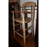 A child's Victorian stripped wood high chair and a Victorian mahogany balloon back dining chair