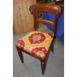 A set of six early 19th century mahogany dining chairs with scroll carved shoulder boards and