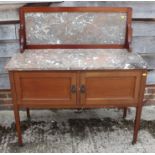 An Edwardian walnut top washstand with splashback and cupboards, on square taper supports, 42" wide,