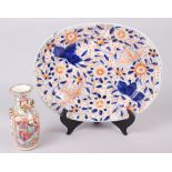 A 19th century Imari porcelain oval dish, 12" long, and a Cantonese famille verte decorated vase, 6"