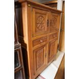 A Belgian carved oak side cupboard, fitted two doors over two drawers with two further doors, on