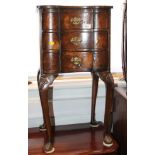A Queen Anne design bedside nest of three drawers, on shell carved cabriole supports, 15" wide
